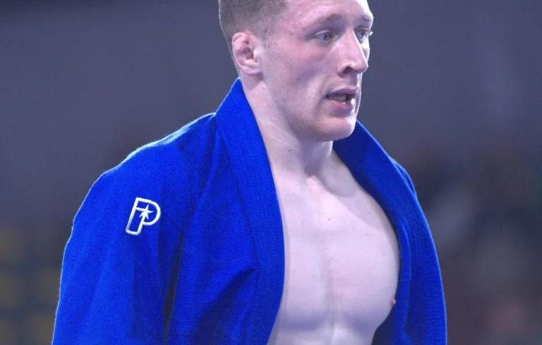 A BJJ player wearing a blue Progress BJJ Gi. Can a White Belt Wear a Blue Gi image.