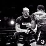No-gi grapplers in rash guards and grappling shorts competing at ADCC