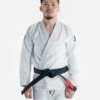 A person wearing Progress The Academy BJJ Gi with a free white belt