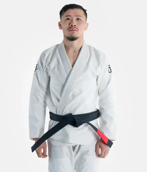 A person wearing Progress The Academy BJJ Gi with a free white belt