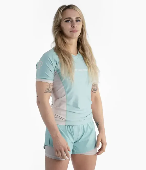 Woman wearing a Progress Academy Women's Rash Guard