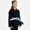 Child wearing a Progress Kids Academy BJJ Gi with a free white belt