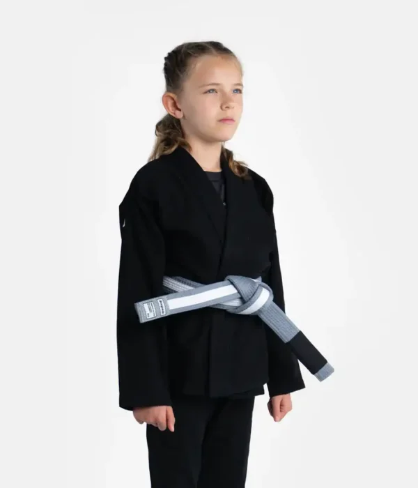 Child wearing a Progress Kids Academy BJJ Gi with a free white belt