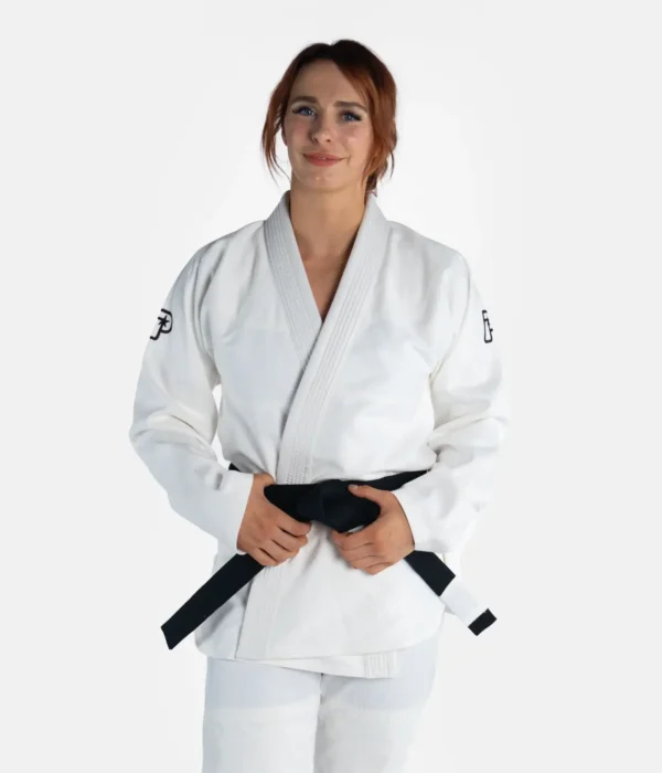 Woman wearing Progress Women's Academy BJJ Gi with a free white belt