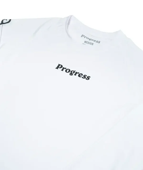 Progress Academy Rash Guard Long Sleeve White 4 Progress Academy Rash Guard Long Sleeve being worn by a martial artist.