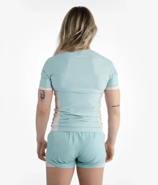 Woman wearing Progress Academy women's rash guard