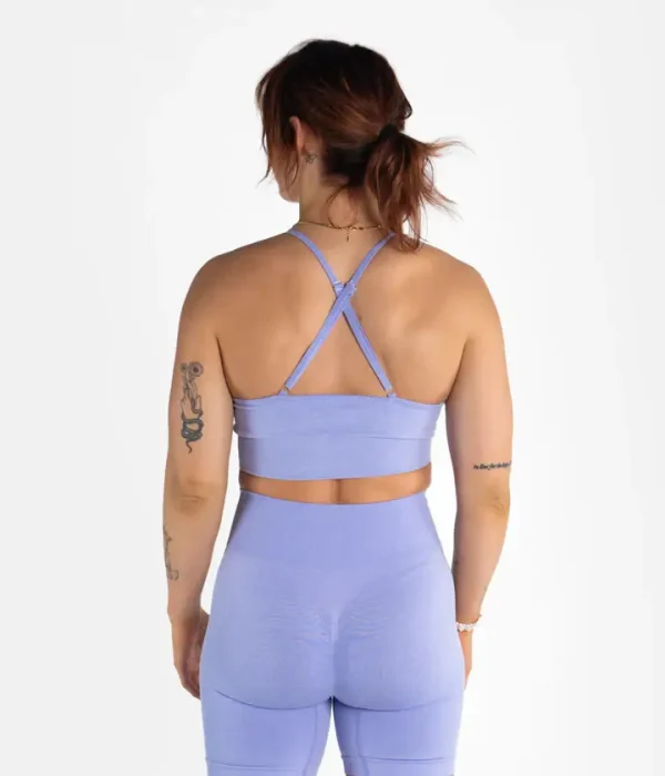 Woman modeling the Progress Eira Ladies Seamless Sports Bra in a gym setting