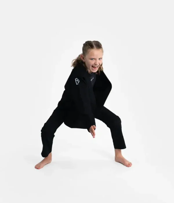 Child wearing Progress Kids Academy BJJ Gi with free white belt.