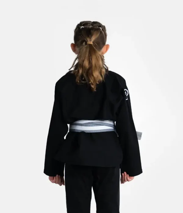Kid wearing Progress Kids Academy BJJ Gi with a free white belt