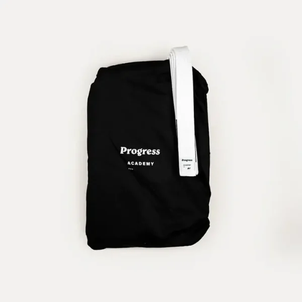 Child wearing Progress Kids Academy BJJ Gi with free white belt