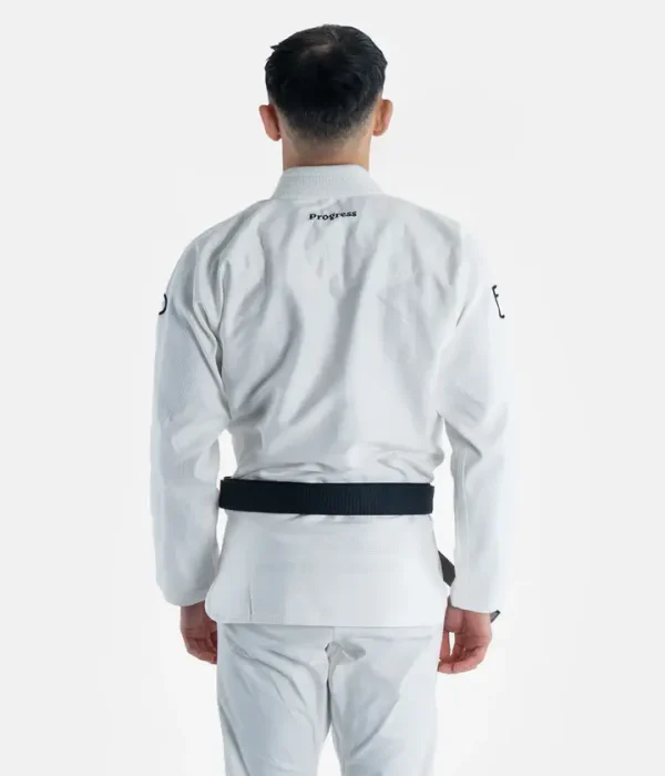 A person wearing Progress The Academy BJJ Gi, with a free white belt included.