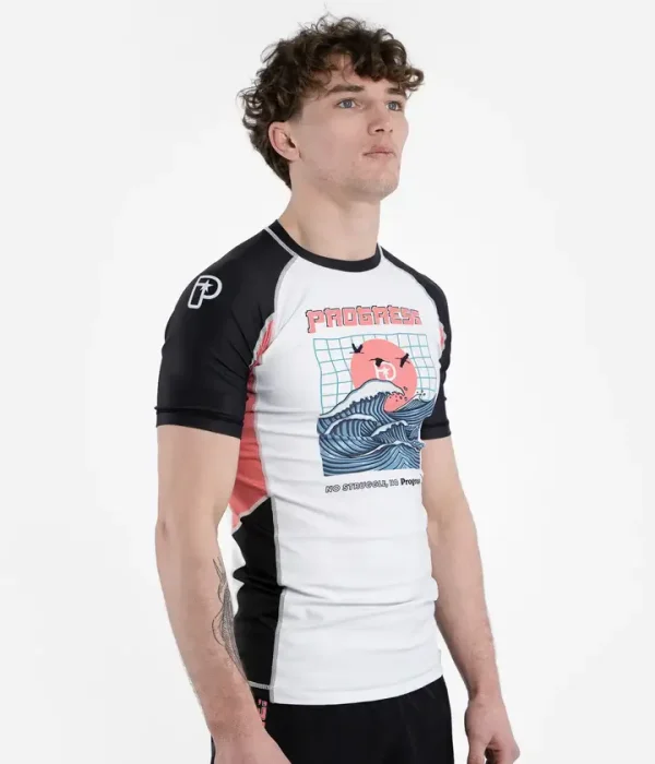 Man wearing Progress Unknown Great Wave Rash Guard designed with dynamic wave print