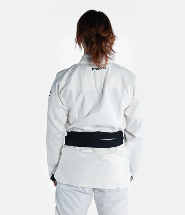 Woman wearing Progress Women's Academy BJJ Gi with a free white belt