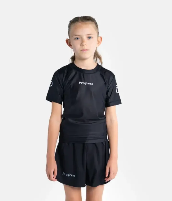 Child wearing Progress Kids Academy Rashguard