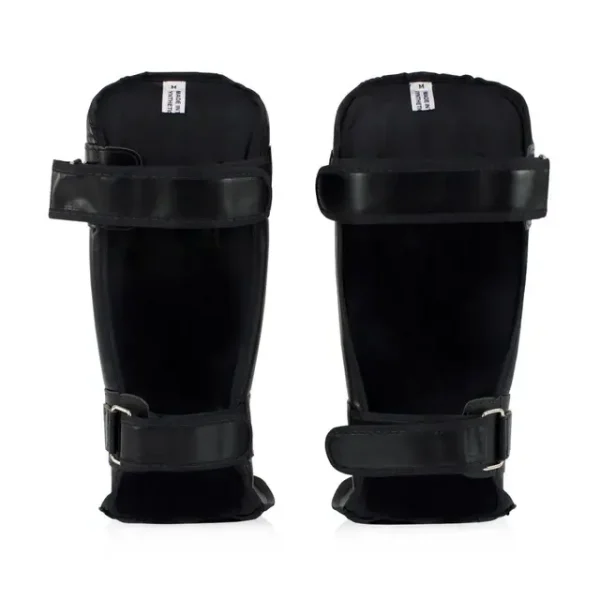 Fairtex Sp3 Double Padded Shin Guards Black 1 Skilled athlete wearing Fairtex SP3 Double Padded Shin Guards for combat sports training