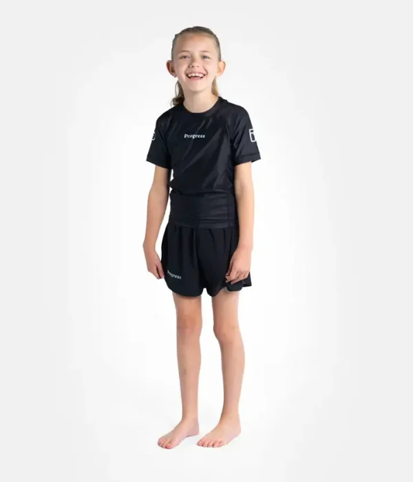 Child modeling Progress Kids Academy Rashguard