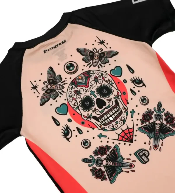 Kid wearing a vibrant Progress Kids Sugar Skull Rash Guard