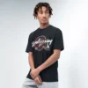 Man wearing Rival Vintage Graphic tee in black with spandex