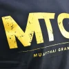 A close-up shot of a Fairtex X MTGP Official T-Shirt