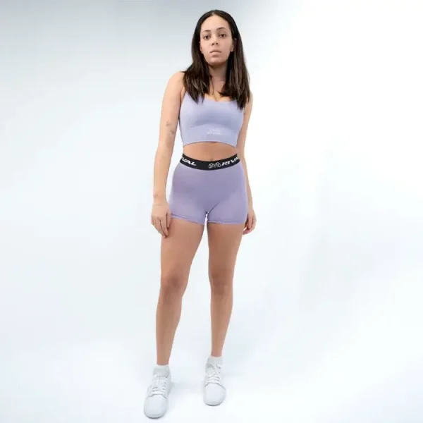 Woman wearing a Rival Buttery Stretch Cross-Back Sports Bra in a gym setting