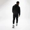 Model sporting black Rival Track Pants