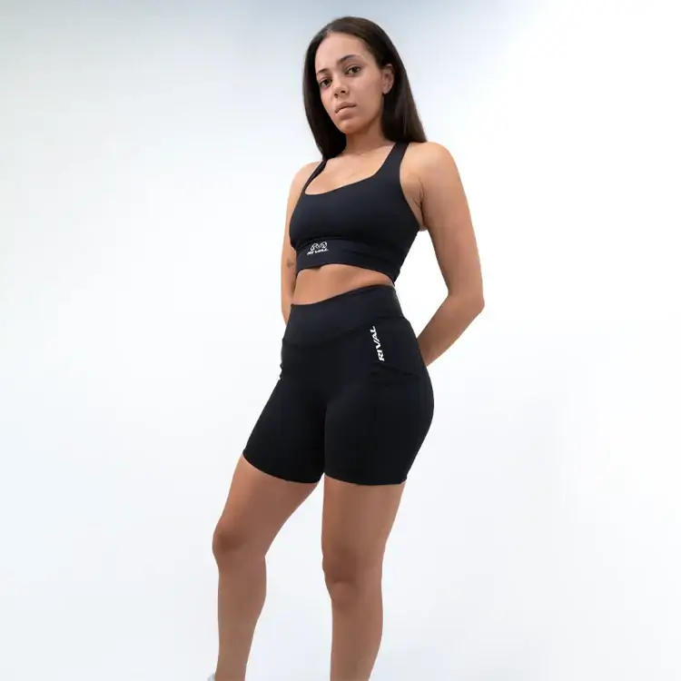 Woman wearing Rival Women's High-Rise Biker Shorts with pockets