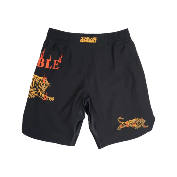 Bright orange tiger print shorts set on a white background