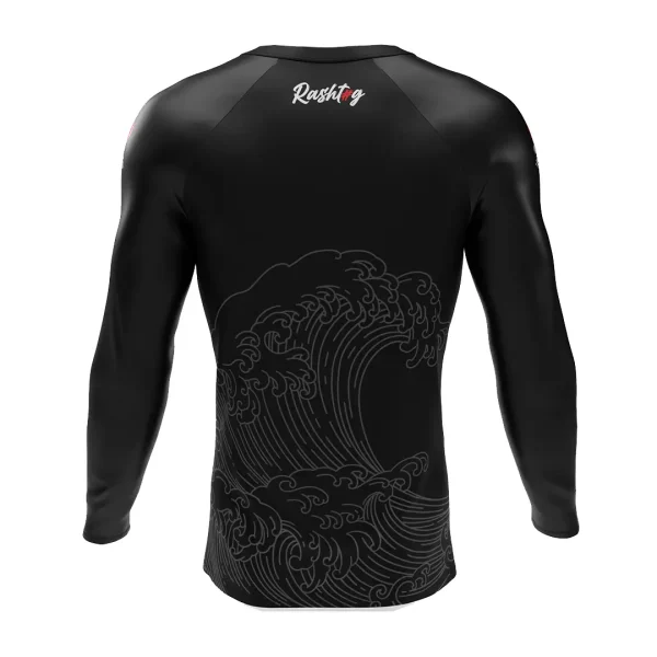 Rashtag Tidal Waves Rash Guard Black 1 Man wearing RashTag Tidal Waves Rash Guard on a background of the sea