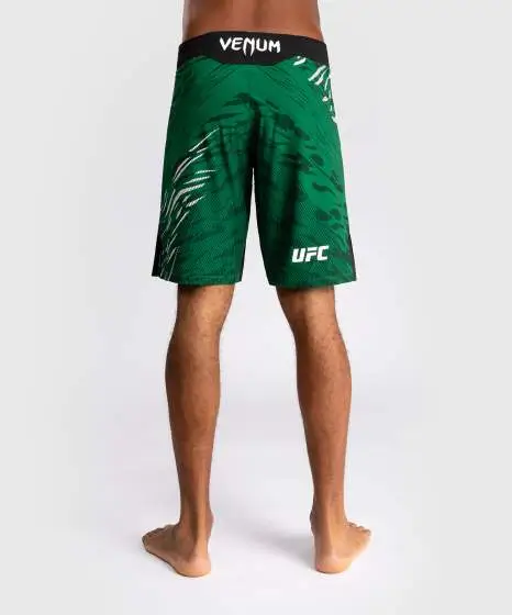 Man wearing Venum x UFC Fusion Authentic Fight Night Men’s Fight Shorts - Long Fit
