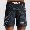 Man wearing Venum x UFC Fusion Authentic Fight Night Men’s Fight Shorts - Short Fit