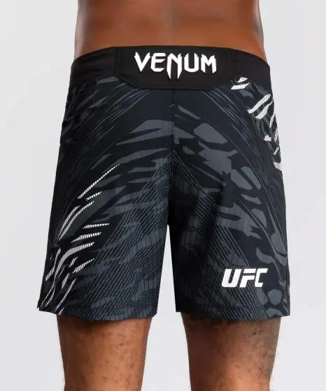Man wearing Venum x UFC Fusion Authentic Fight Night Men’s Fight Shorts - Short Fit