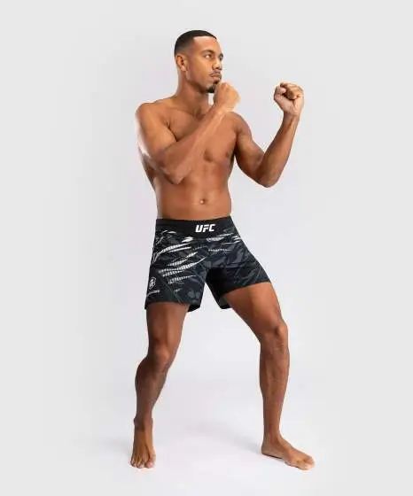 Venum x UFC Fusion Authentic Fight Night Men's Fight Shorts - Short Fit displayed on a minimalistic background.