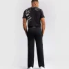 A man wearing Venum x UFC Fusion Authentic Fight Night Men's Straight Leg Walkout Jogger Pants