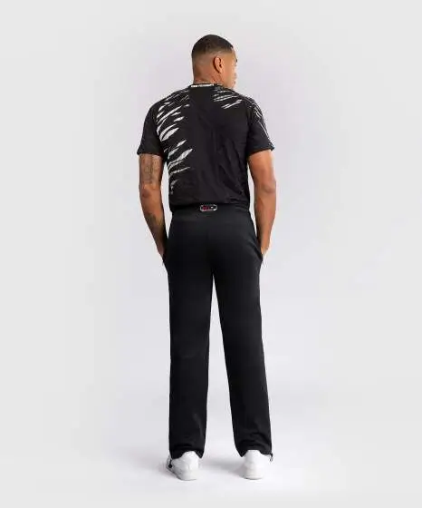 A man wearing Venum x UFC Fusion Authentic Fight Night Men's Straight Leg Walkout Jogger Pants