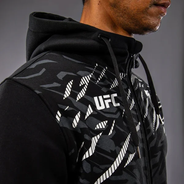 Man wearing Venum x UFC Fusion Men's Replica Zip Hoodie
