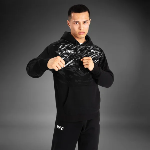 Venum X Ufc Fusion Replica Mens Pullover Hoodie Black 4 A man wearing a Venum x UFC Fusion Replica Men's Pullover Hoodie