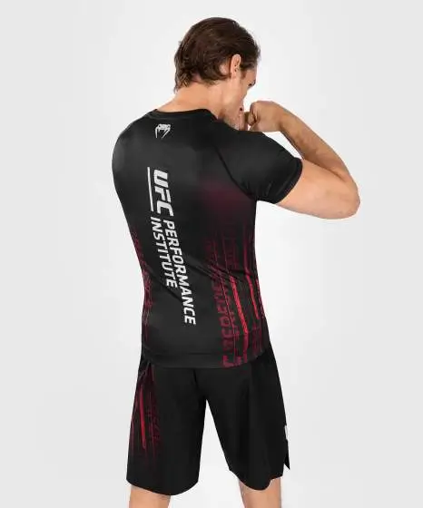 Man wearing Venum x UFC Performance Institute 2.0 Men's Short Sleeve Rashguard
