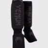Venum Kontact Cotton Shin Guards in black and white color.