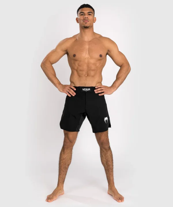 Man wearing Venum Contender fight shorts in a fighting stance