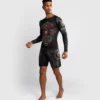Man wearing Venum Santa Muerte 5.0 Long Sleeve Rashguard.