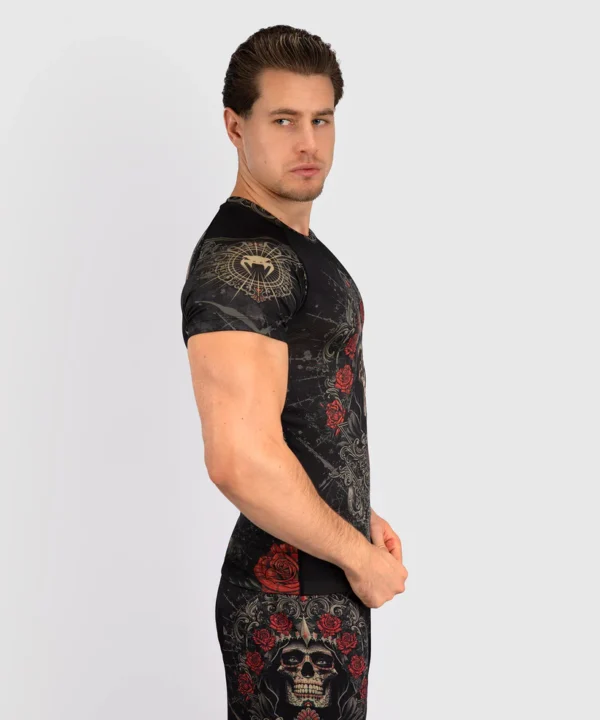 A man wearing Venum Santa Muerte 5.0 Short Sleeve Rashguard