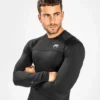 Man wearing the black Venum G-Fit Air Long Sleeve Rash Guard