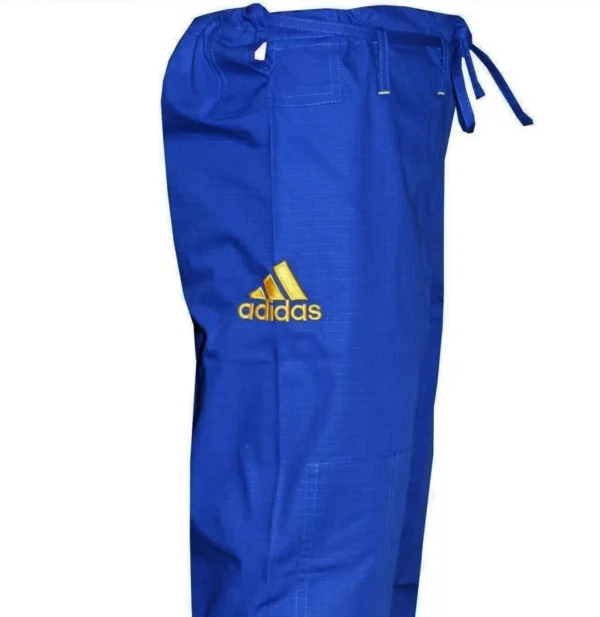 Adidas Kids BJJ Gi Uniform Kid wearing Adidas Kids BJJ Gi Response 265g Uniform