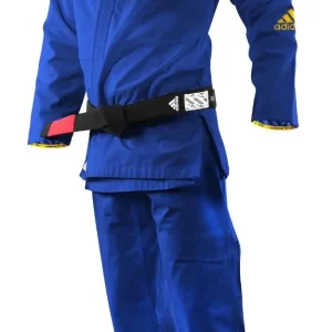 A child modeling the Adidas Kids BJJ Gi Response 265g Uniform.