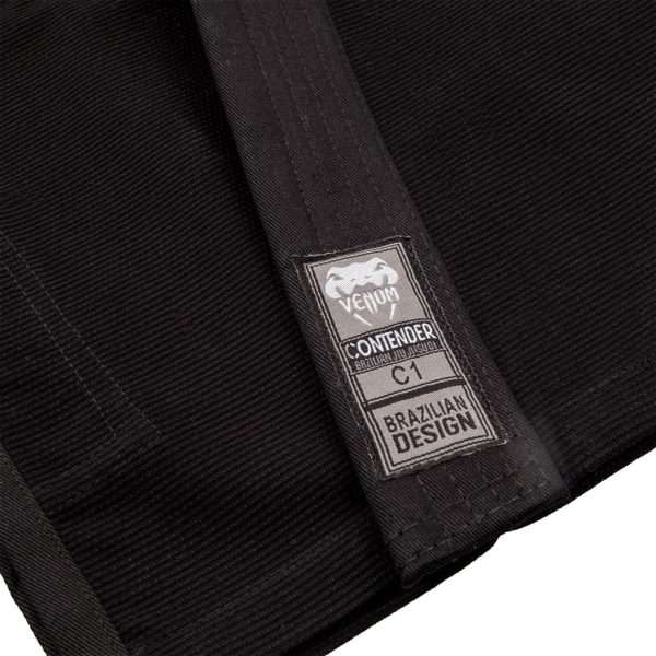 Kid wearing Venum Contender Kids BJJ Gi with a white belt