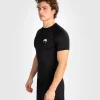 Venum Contender Short Sleeve Mens Rash Guard Black 1 Venum Contender Short Sleeve Men's Rash Guard in a professional setting