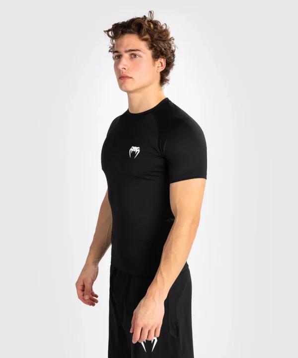 Venum Contender Short Sleeve Mens Rash Guard Black 1 Venum Contender Short Sleeve Men's Rash Guard in a professional setting