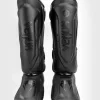 Venum Elite Evo Shin Guards laid out on a white background