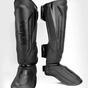 Venum Elite Evo Shin Guards worn by a martial artist