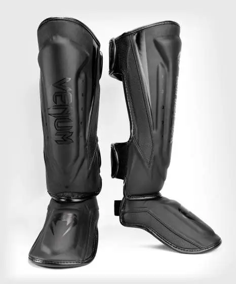 Venum Elite Evo Shin Guards worn by a martial artist